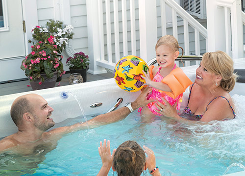Boy playing with beach ball in the h2x swimspa